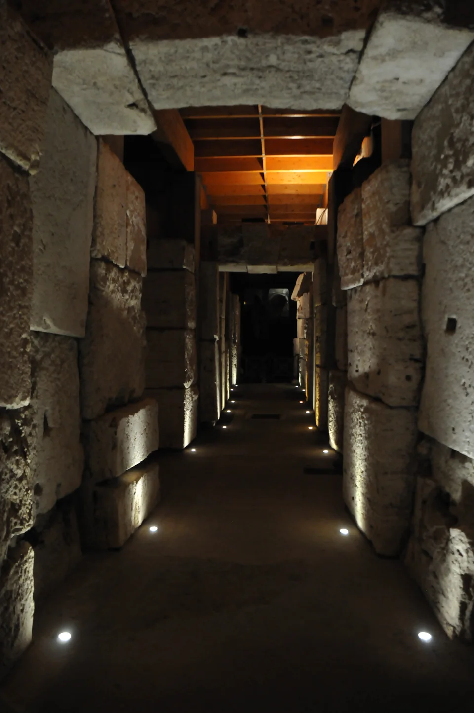 A lit stone passage in the Colosseum